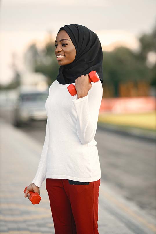 woman on street doing a bicep curl