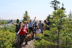 A group of people hiking the Sussex Bluffs Nature Trail.