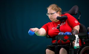 Paralympian Alison Levine getting ready to throw a boccia ball.