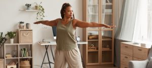 A woman doing yoga in a living room.