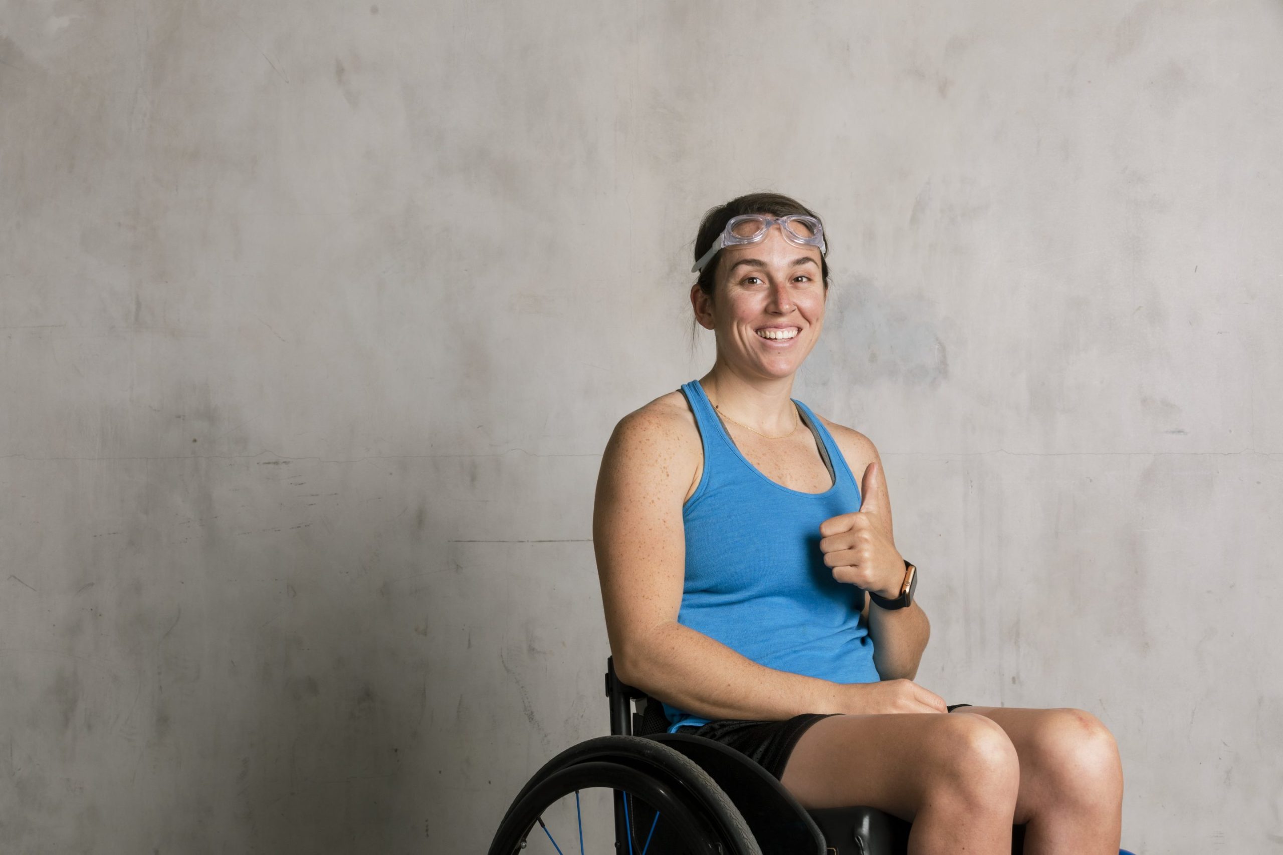 Woman giving a thumbs up in a wheelchair