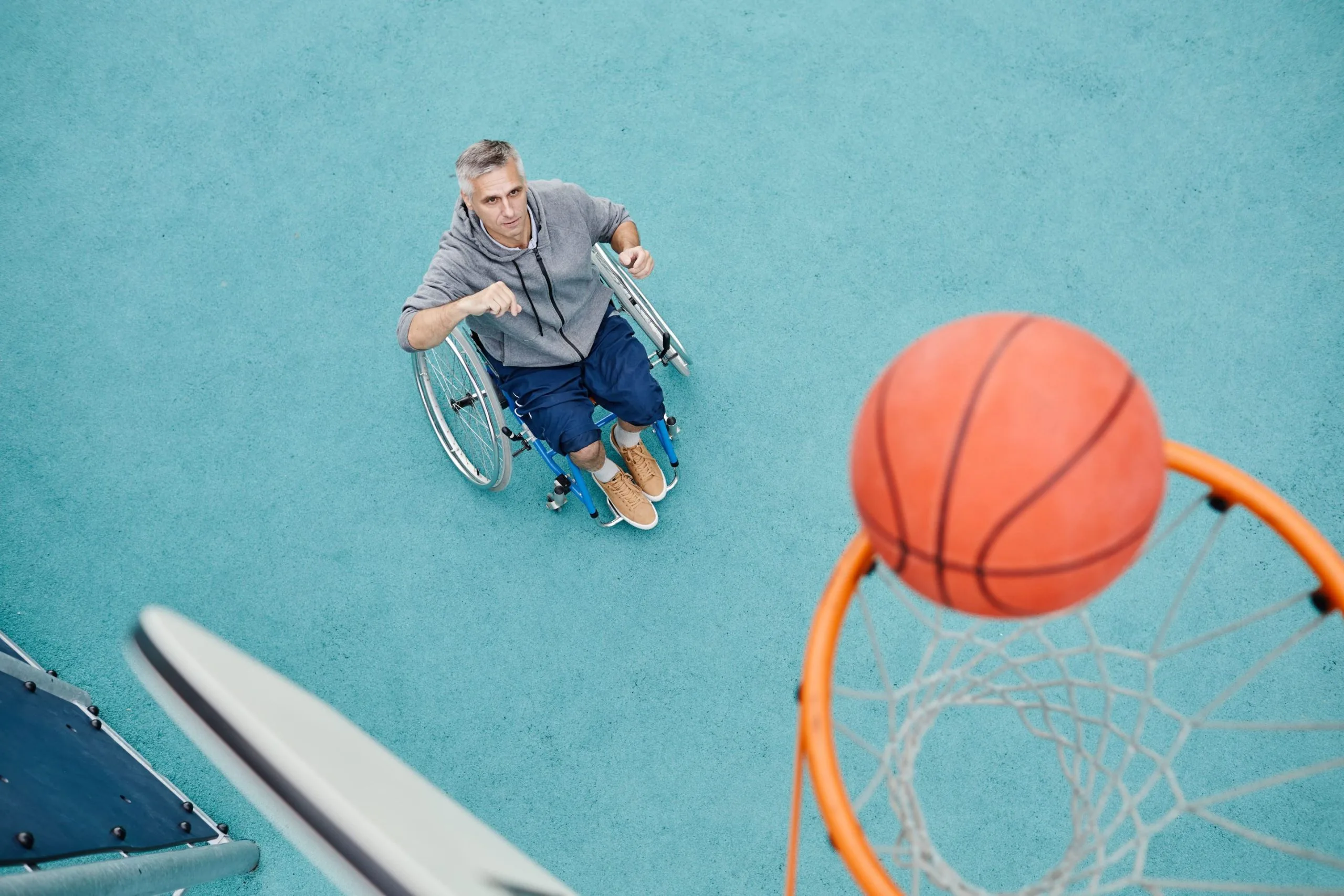 Man in wheelchair playing basketball